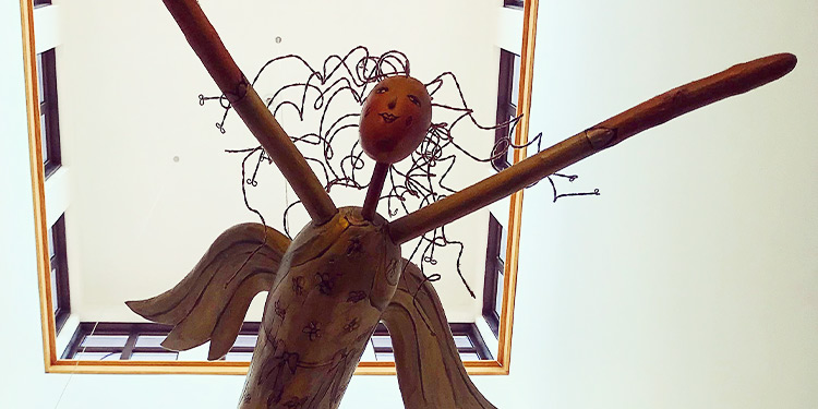Hanging wooden angel sculpture
