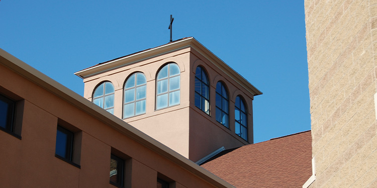 Exterior of church; closeup on widows and cross