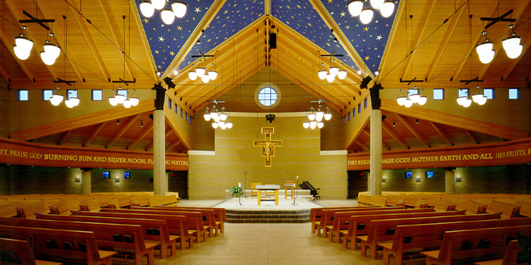 Interior of Saint Francis church; view of pews, altar, cross, and starry ceiling