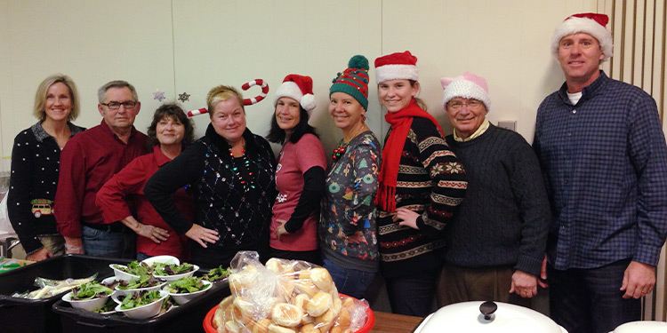 Team support Homeless & Hungry poses for a photo at Christmas time
